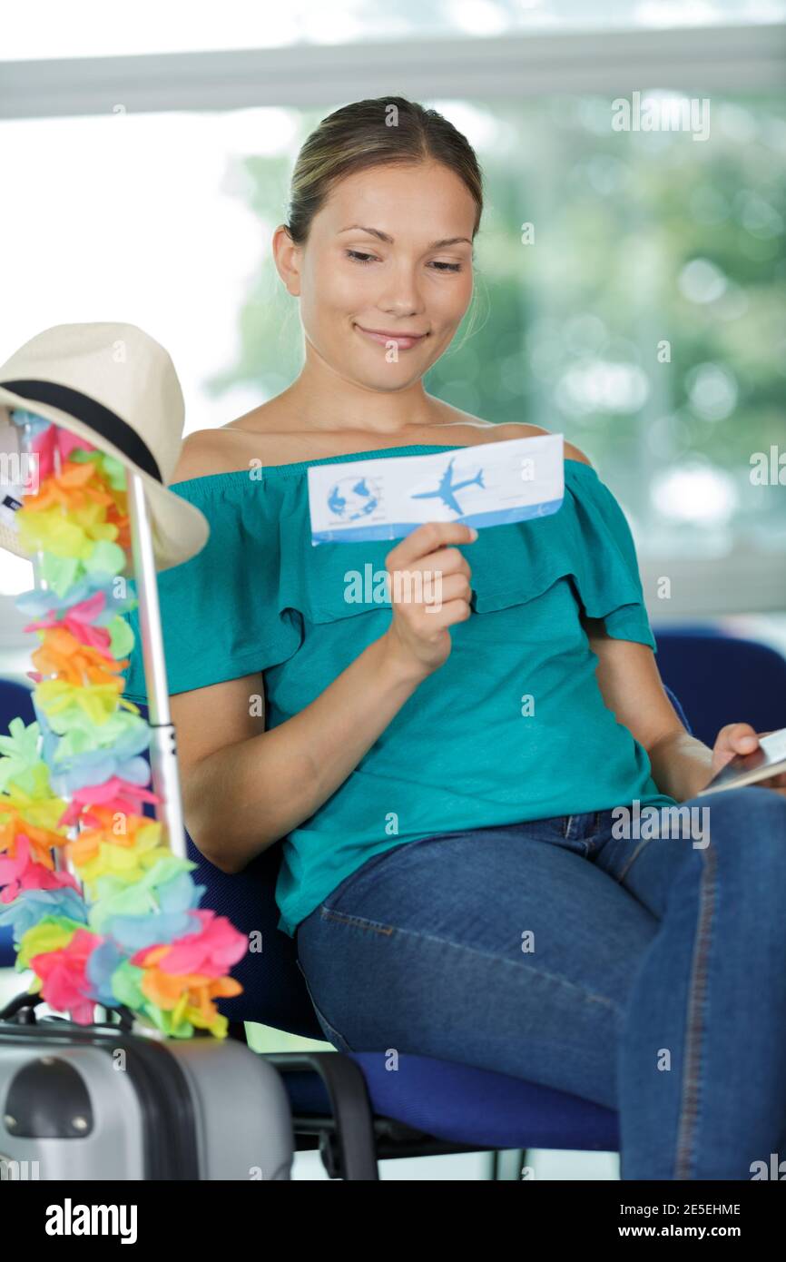 woman in the airport reading ticket Stock Photo - Alamy