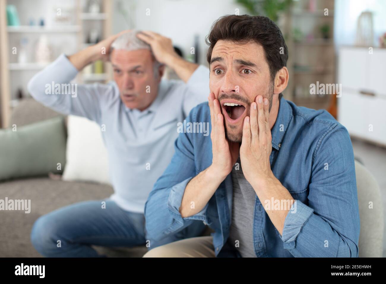 two generations of men frustrated by favourite football team failure Stock Photo