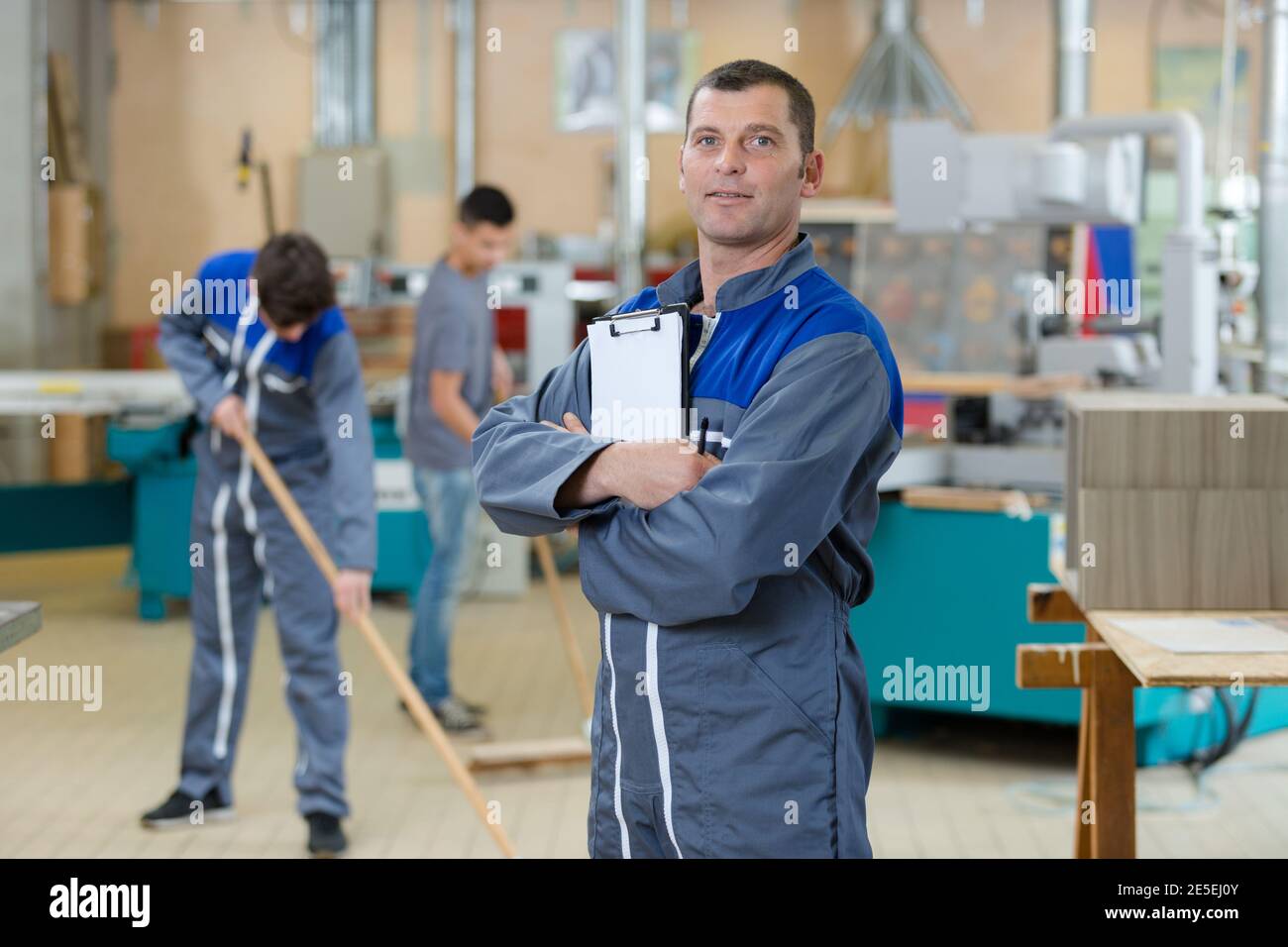 mechanic man holding a pen and a folder Stock Photo