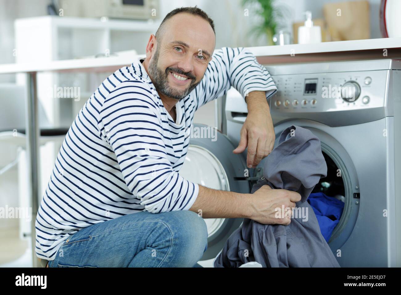 husband man doing laundry at home Stock Photo Alamy