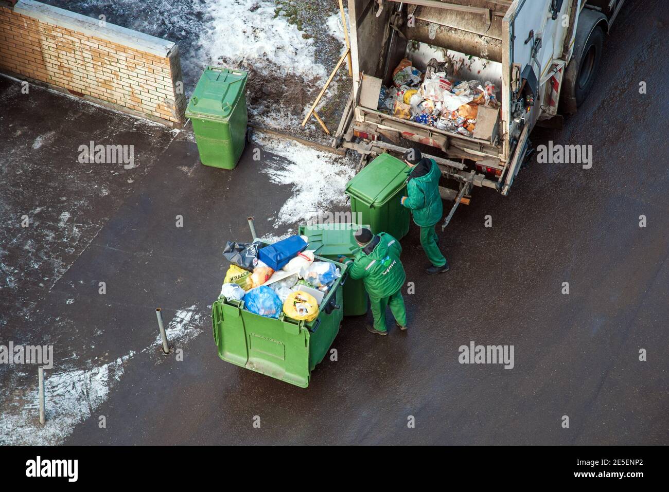 Garbage men collecting mixed household waste for separating and recycling, Moscow, 27.01.2020 Stock Photo