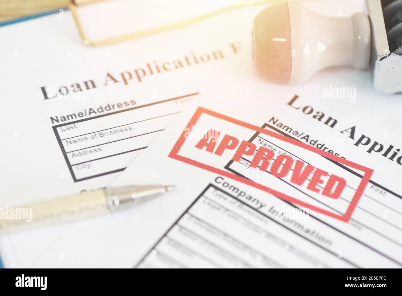 Loan application form with Rubber stamping that says Loan Approved, Financial loan money contract agreement company credit or person - loan approval Stock Photo