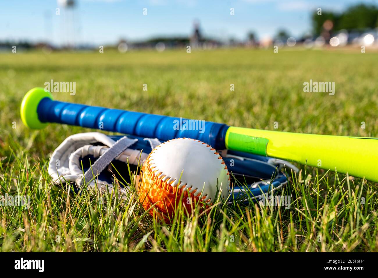Close focus on baseball equipment with defocused players in background