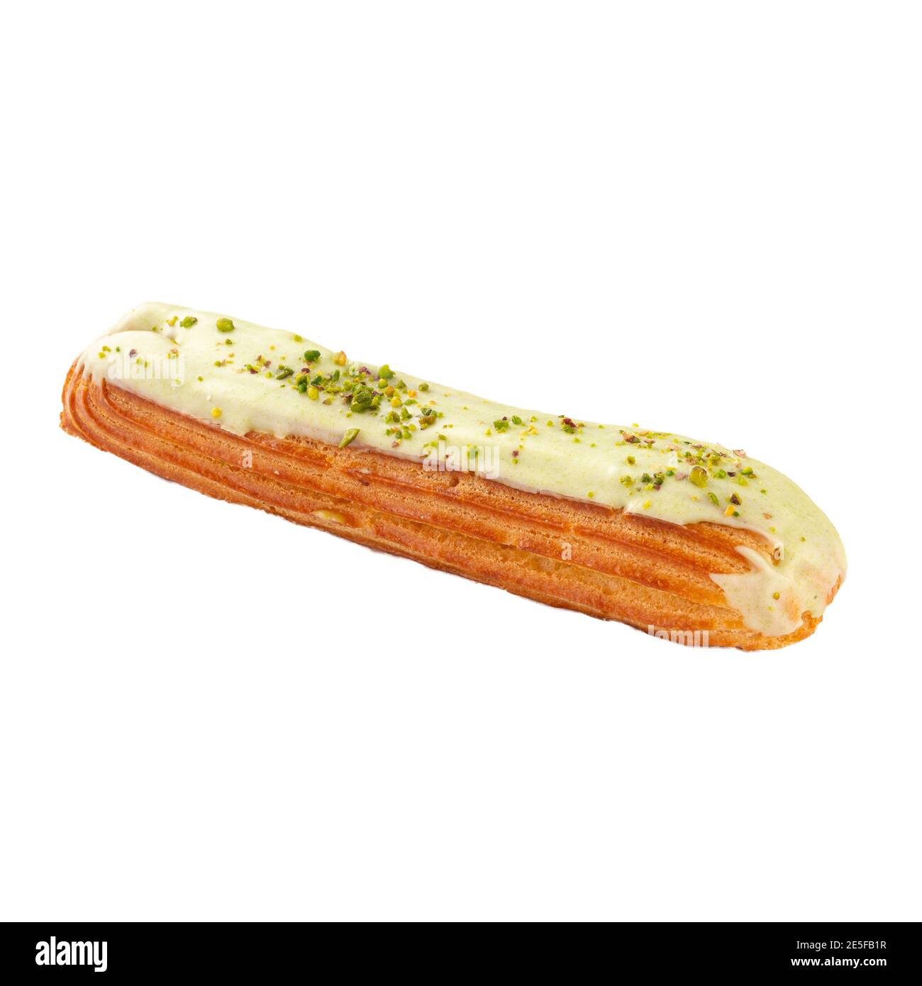 Isolated pistachio eclair brewing cake on white Stock Photo