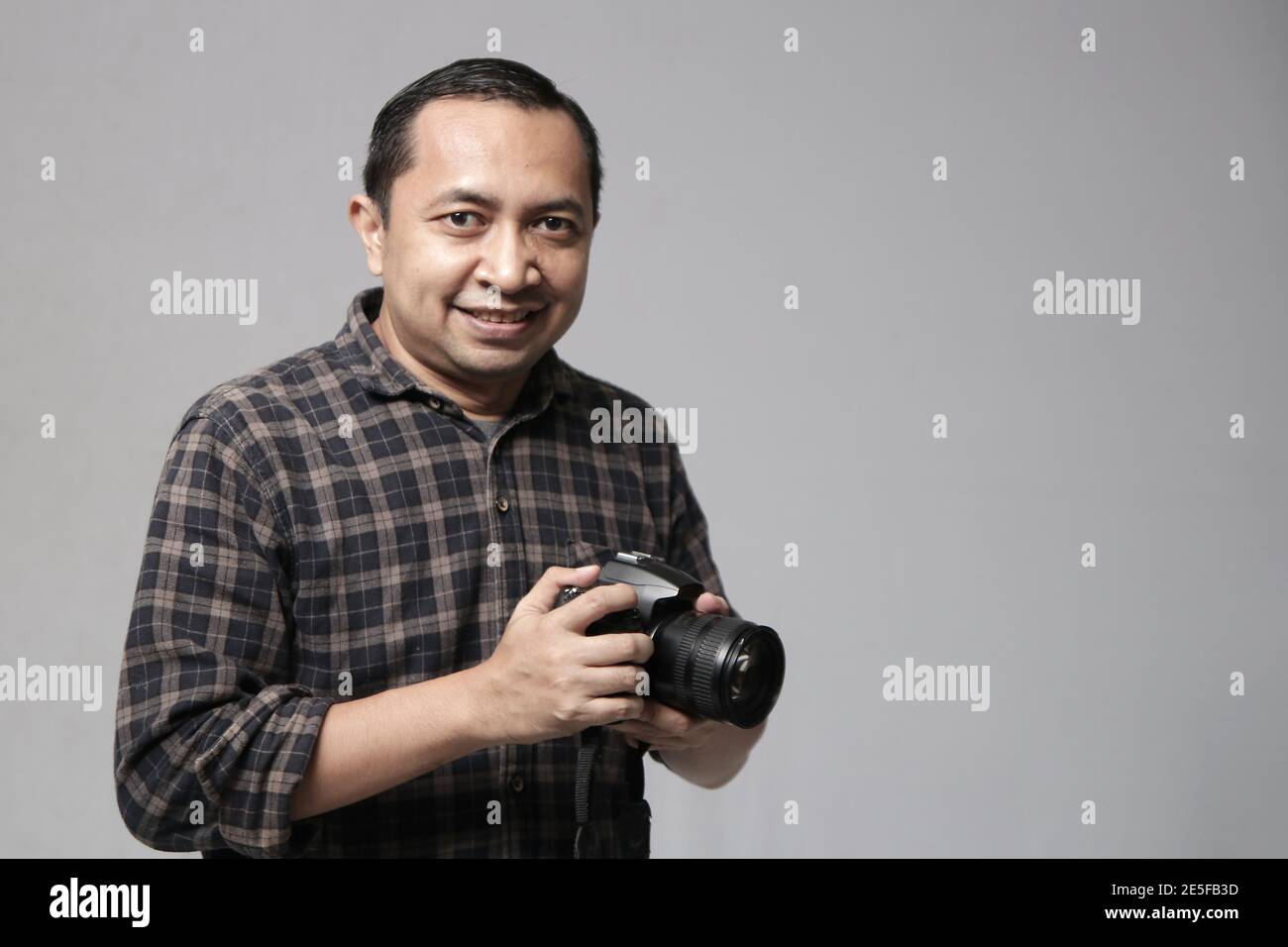 a man with camera, photographer with camera, making picture with his ...
