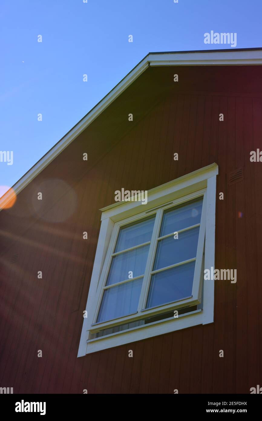Traditional Scandinavian red and white house with modern windows and lens flare Stock Photo Alamy