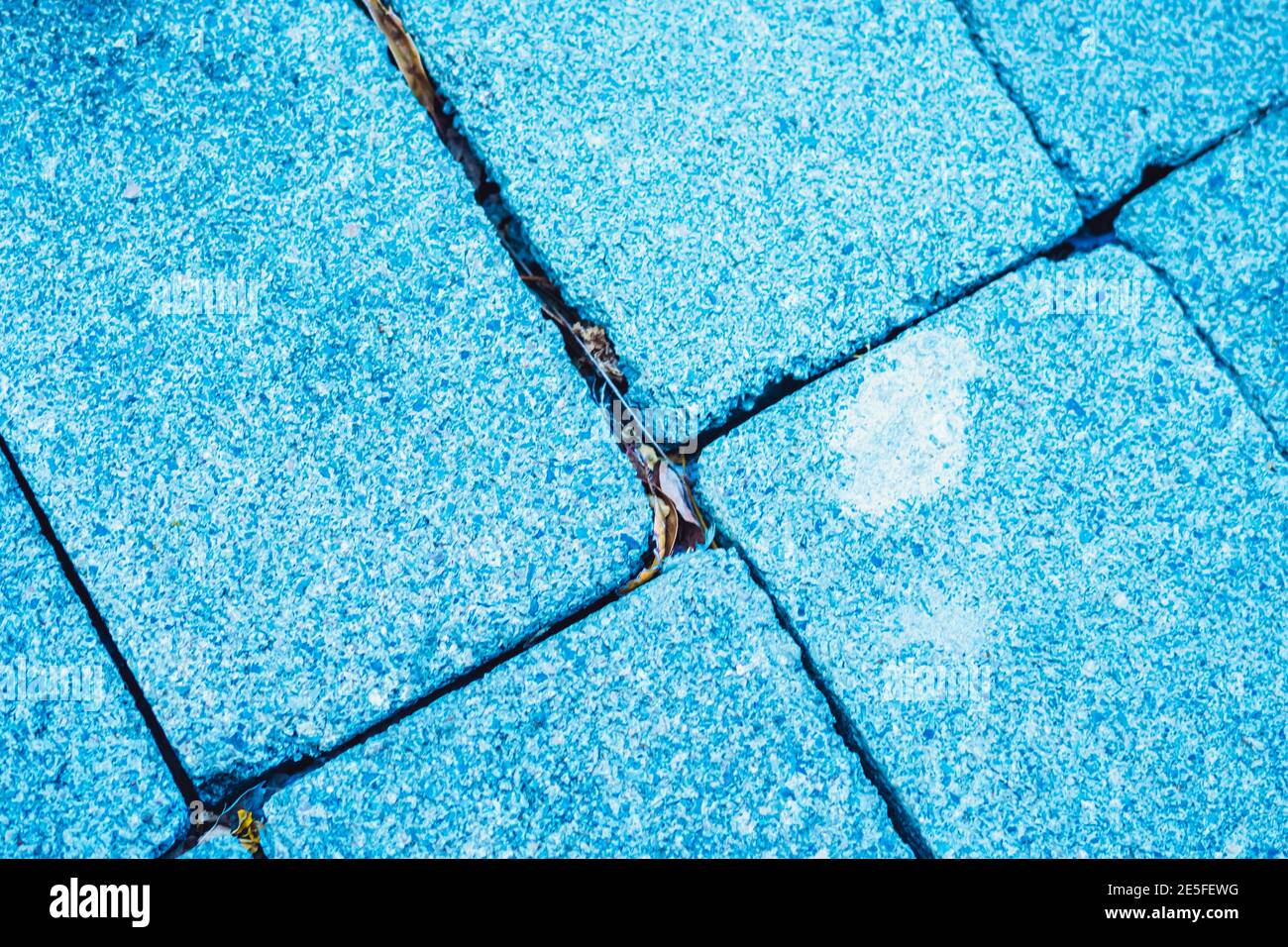 Close-up view rectangular paving stone concrete tile brick. Blue toned ...