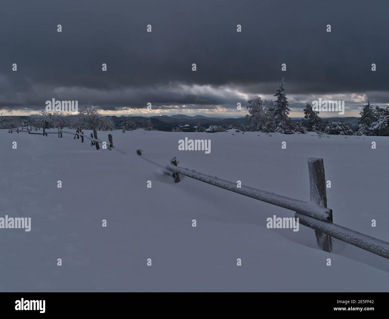 Stunning winter landscape with wooden fence covered by deep snow ...
