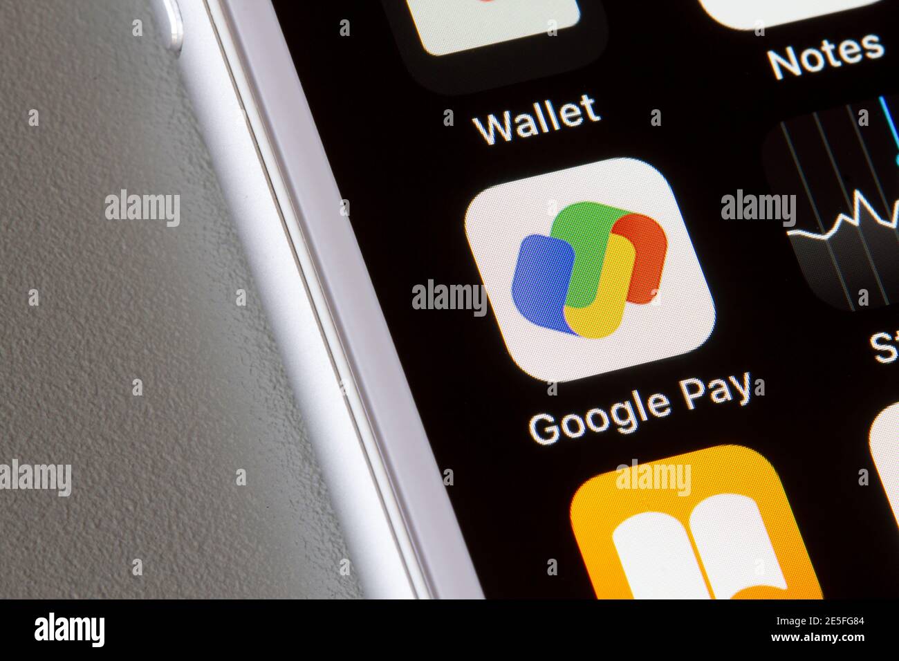 Google Pay app icon is seen on an iPhone. Google Pay is a digital wallet platform and online payment system to power in-app and tap-to-pay purchases. Stock Photo