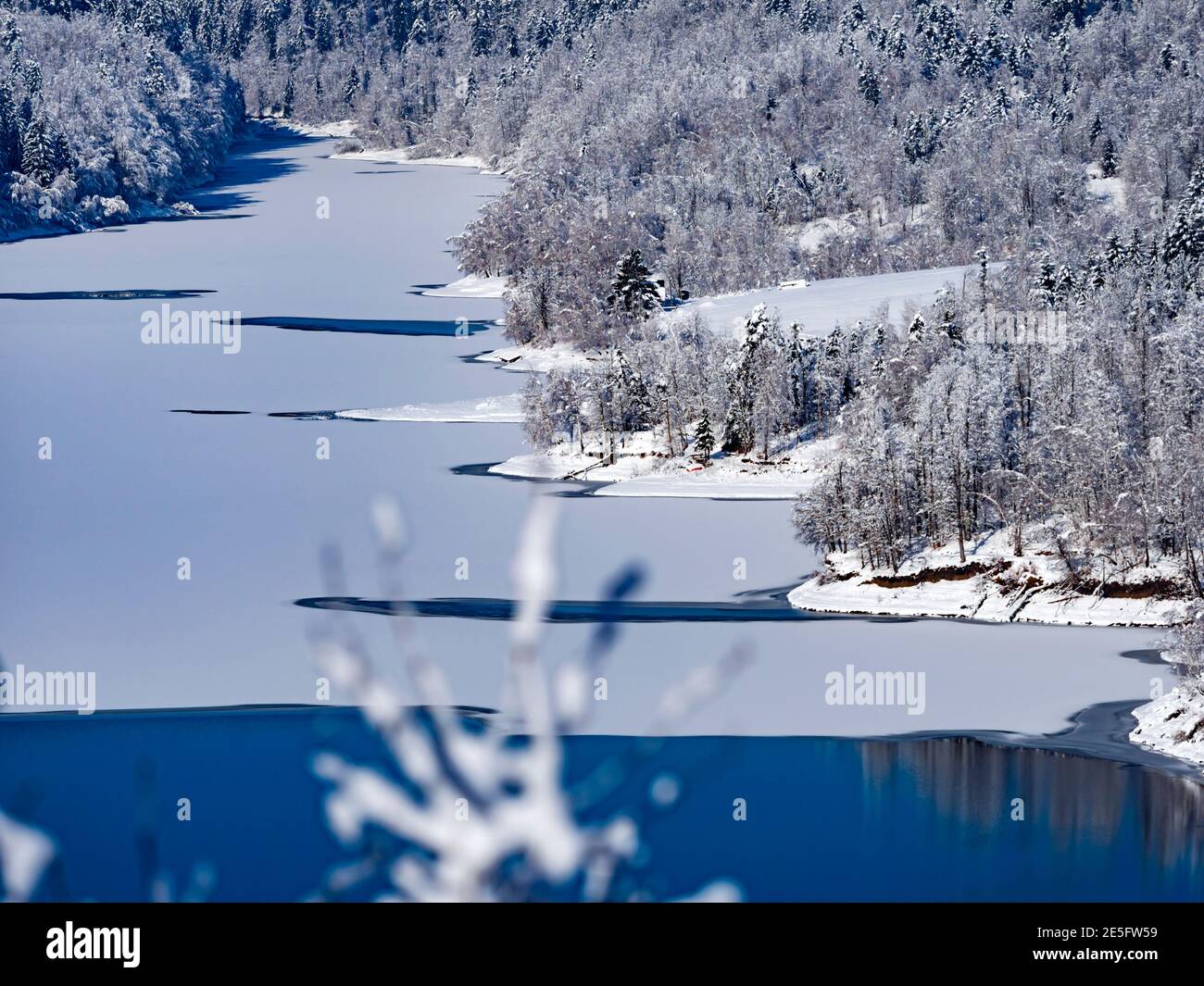 Winter scenery scenic with snow cover Lokve lake Lokvarsko jezero in Croatia Europe partly frozen water suface Stock Photo