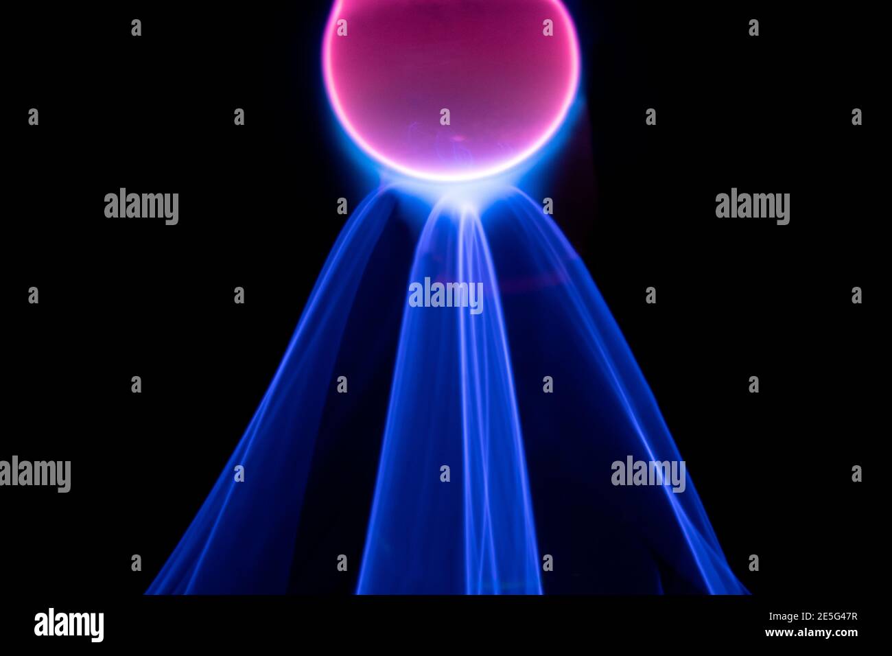 Plasma electric ball lightning lamp. Fascinating space video, close-up of electrical discharges with blue flames on a dark background. Stock Photo