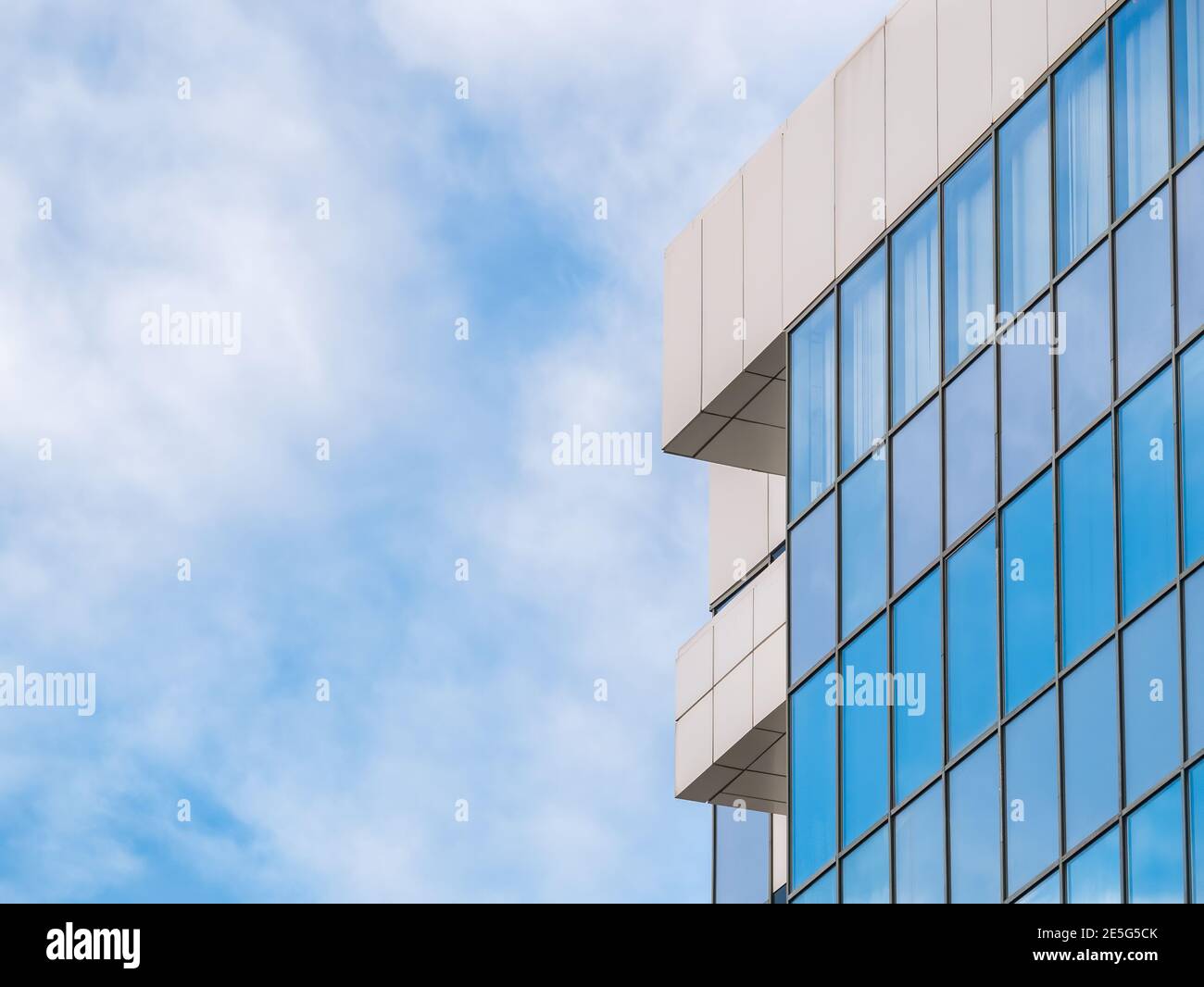 Modern glass office building agaist the cloudy sky Stock Photo - Alamy