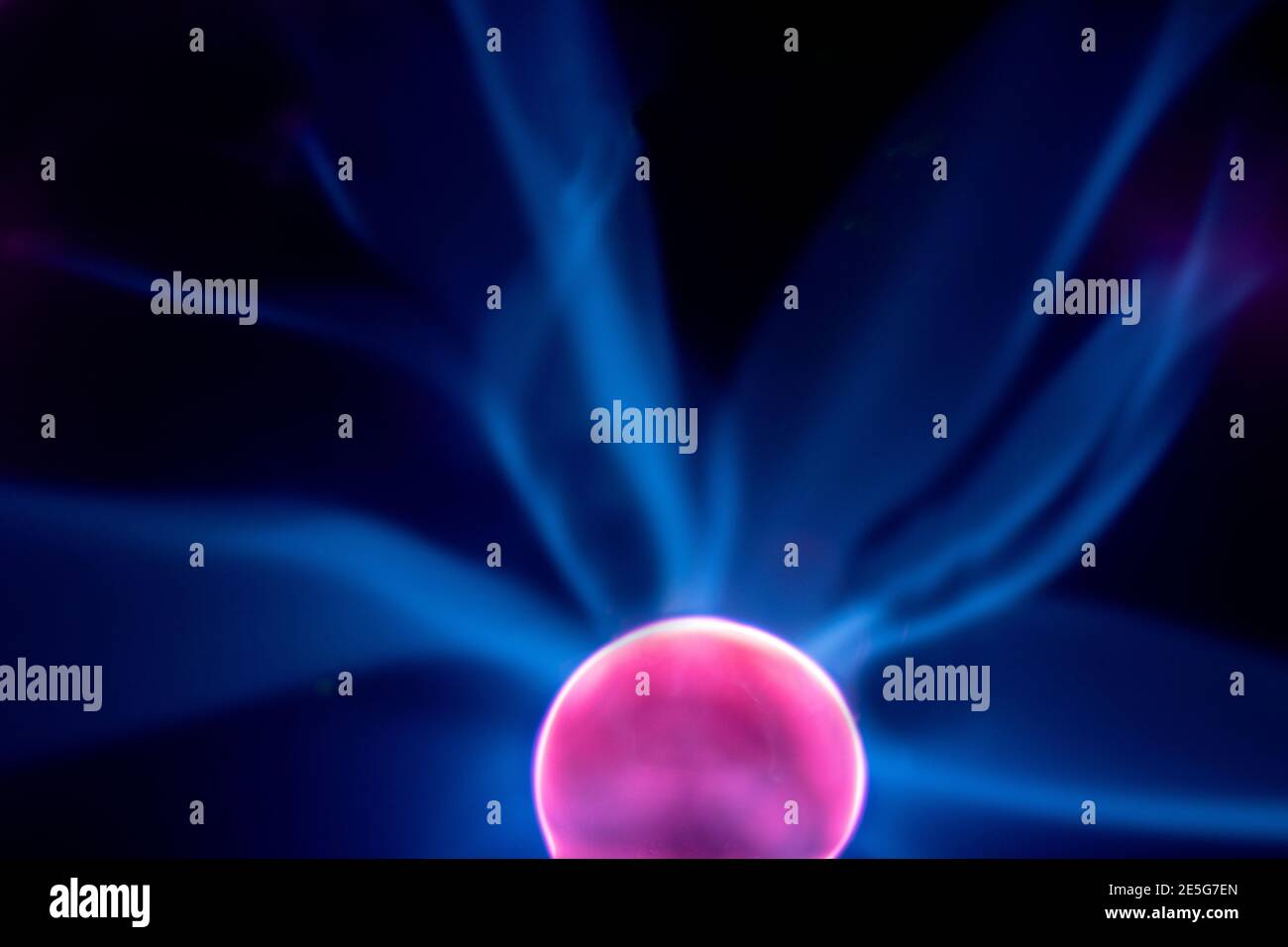 Plasma electric ball lightning lamp. Fascinating space video, close-up of electrical discharges with blue flames on a dark background. Stock Photo
