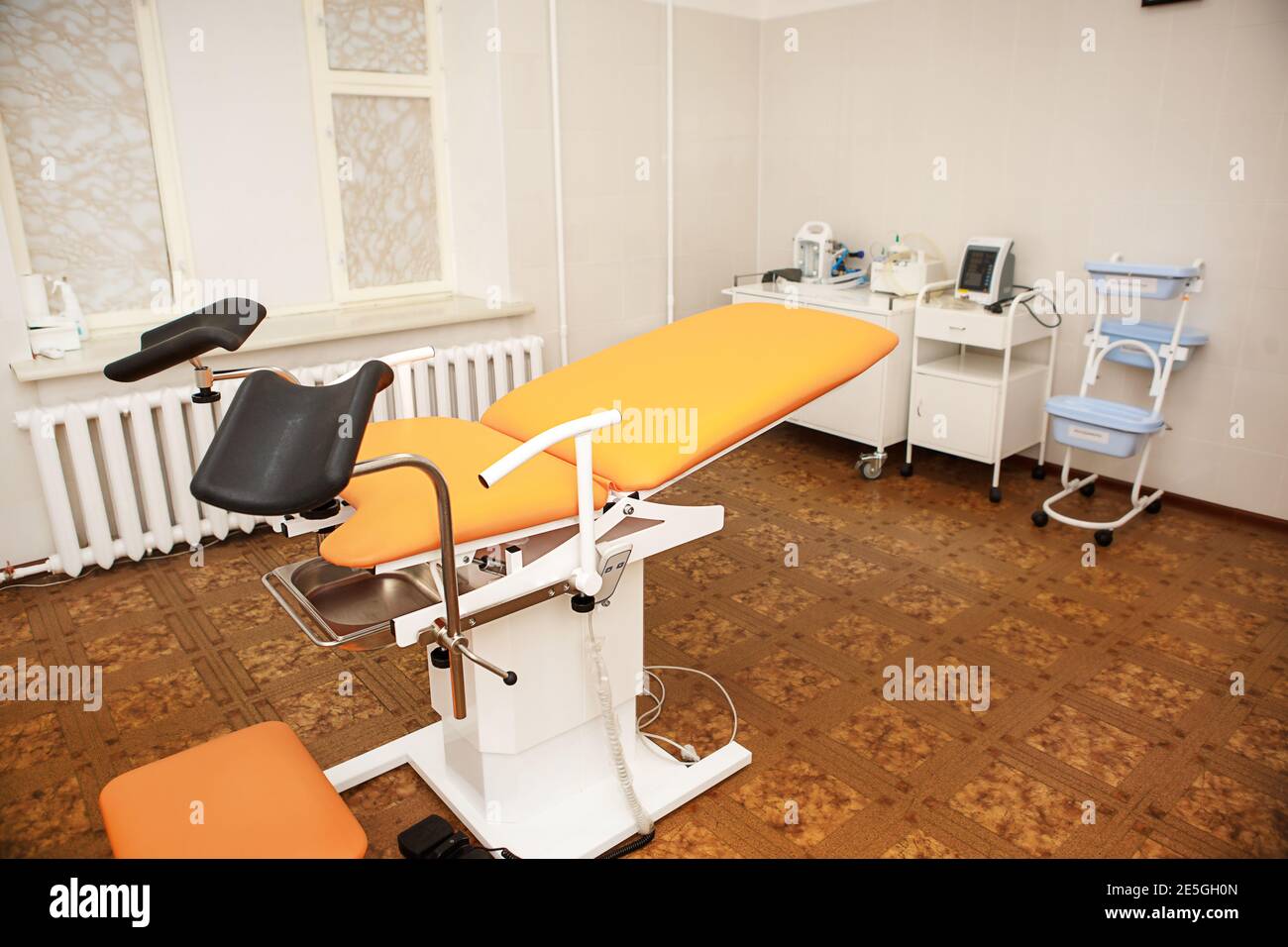 Gynecological chair in the clinic for artificial insemination and reproduction of women. Couch and medical equipment for examination, termination of p Stock Photo