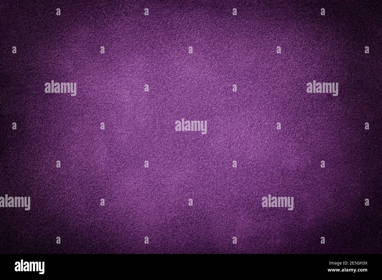 Dark purple matte background of suede fabric with vignette, closeup