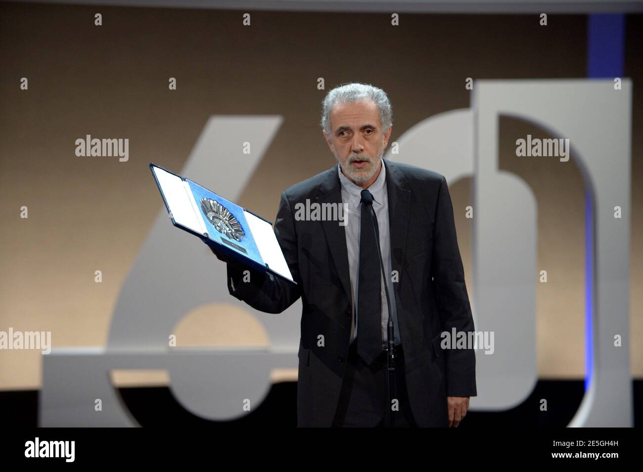 Spanish director Fernando Trueba holds up the Concha de Plata (Silver Shell) award for Best Director for his film 'El Artista Y La Modelo' (The artist and the model) during the awards ceremony at the Kursaal Centre on the final day of the 60th San Sebastian Film Festival September 29, 2012. REUTERS/Vincent West (SPAIN - Tags: ENTERTAINMENT) Stock Photo