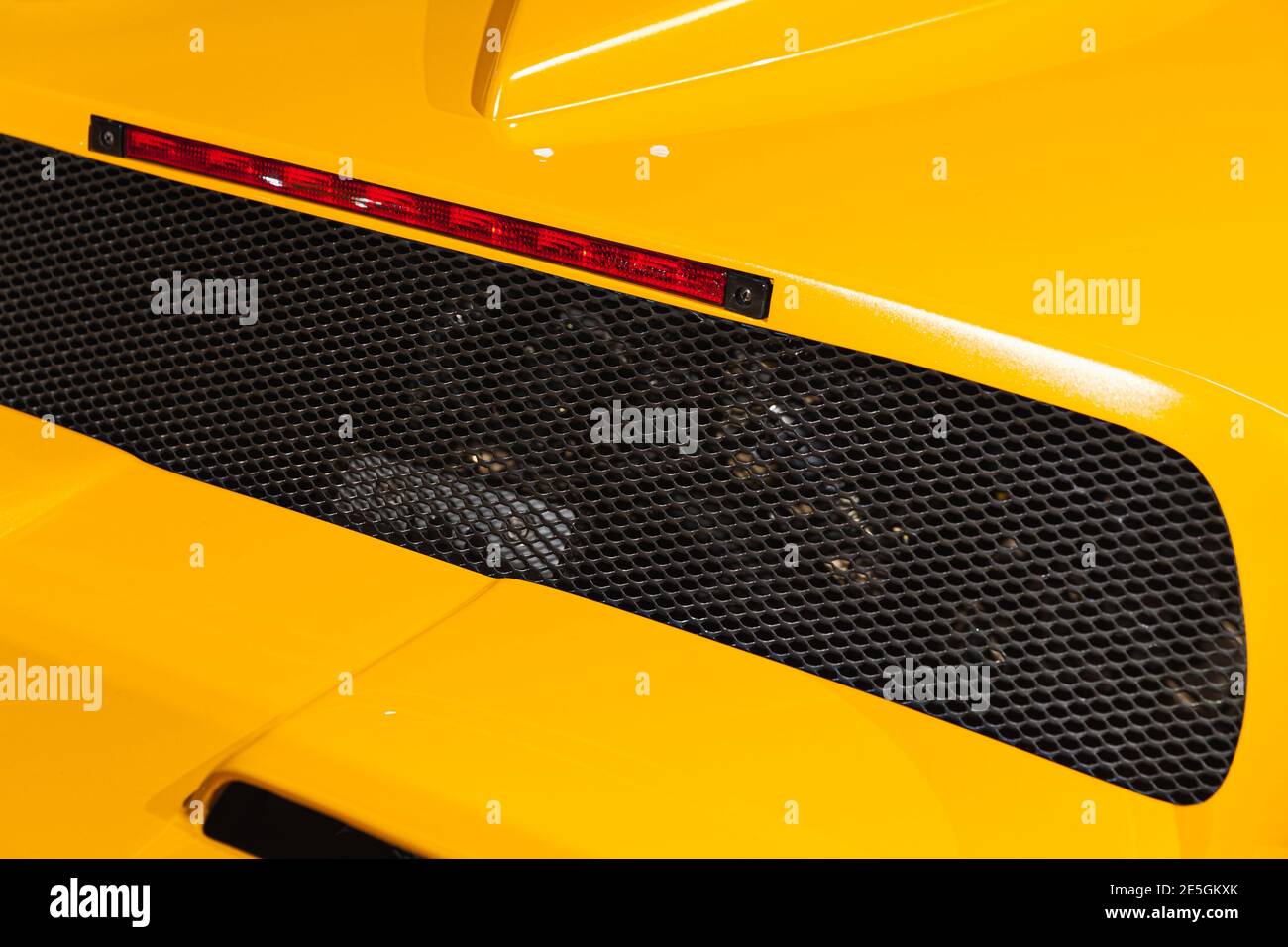 Luxury yellow roadster fragment. Rear ventilation grate and stop lights. Italian car design Stock Photo