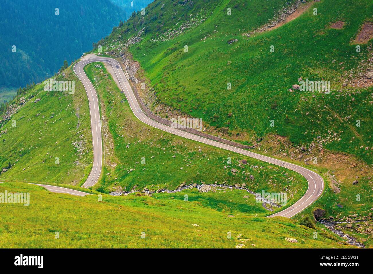 road in high mountains of romania. popular travel destination of fagaras ridge. route 7c is also known as transfagarasan. dramatyc summer weather with Stock Photo