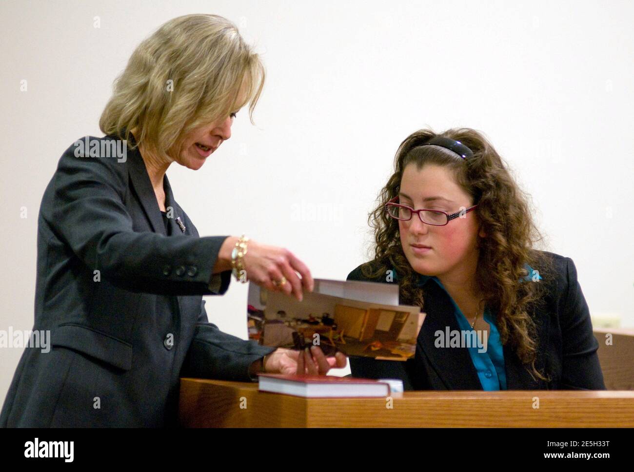 Julia L. McClure, 1st Assistant Prosecutor for Middlesex County, shows  photos to Cassandra Cicco, the roommate of Molly Wei, during the trial of  Dharun Ravi, a Rutgers University student charged with bias