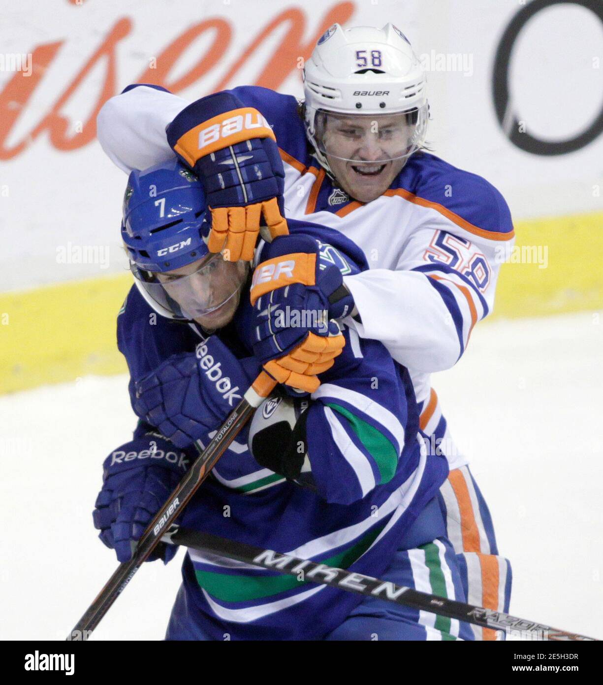 Vancouver Canucks' David Booth (front) is roughed up by Edmonton Oilers' Jeff Petry during the third period of their NHL hockey game in Vancouver, British Columbia April 7, 2012. REUTERS/Ben Nelms (CANADA - Tags: SPORT ICE HOCKEY) Stock Photo