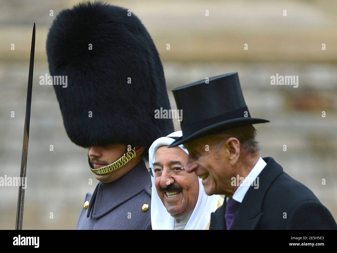 The Emir of Kuwait, Sheikh Sabah al-Ahmad al-Sabah (C), talks to Britain's Prince Philip (R) as he inspects members of the 1st Battalion Irish Guards at Windsor Castle in Windsor, southern England November 27, 2012. The Emir arrived at Windsor Castle on Tuesday for the start of a state visit to Britain.    REUTERS/Toby Melville (BRITAIN - Tags: ENTERTAINMENT POLITICS SOCIETY ROYALS) Stock Photo