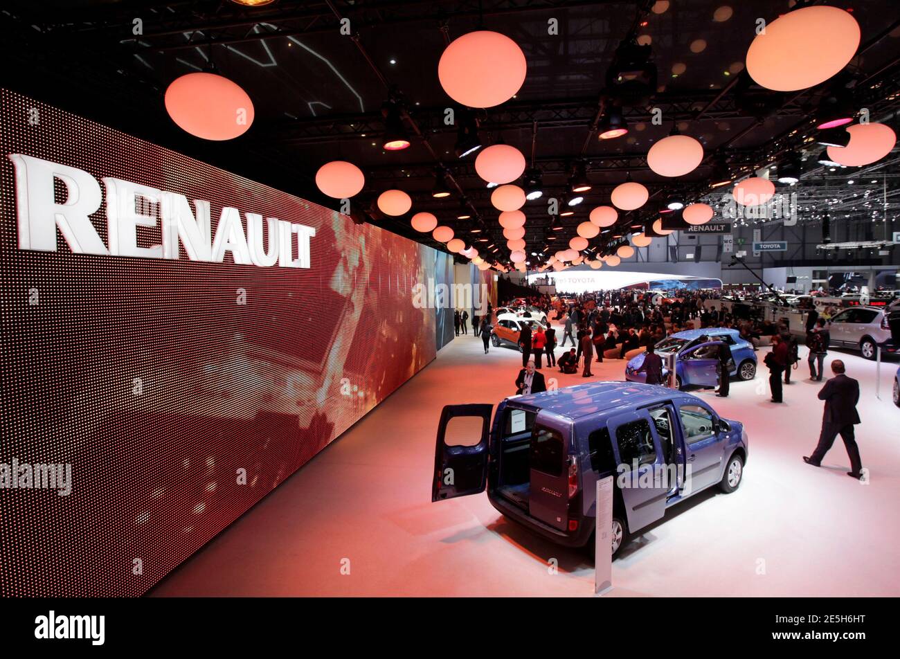 Visitors walk around the exhibition stand of Renault during the first media  day of the Geneva Auto Show at the Palexpo in Geneva March 5, 2013. The  Geneva Motor Show will take