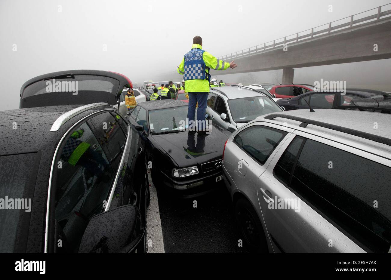 A First Aid Worker Stands On A Car At The Site Of A Pileup On The A9 Motorway Near Chexbres March 30 2013 About 50 Cars Were Involved In The Pileup But