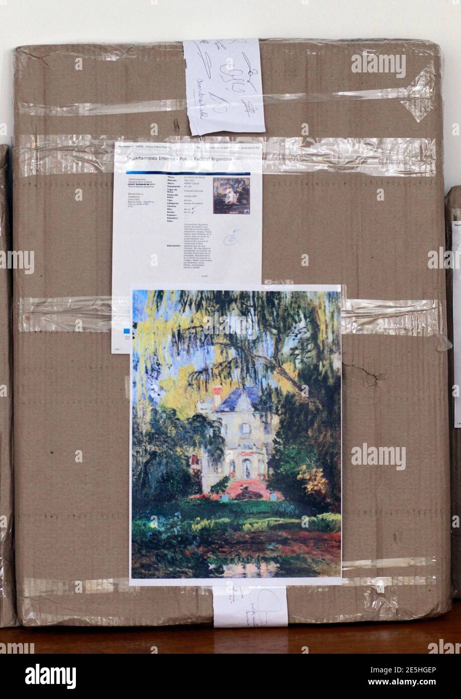 A box containing the painting "La maison de Yerres" by Claude Monet is  shown with a reproduction copy stamped on it at the Argentine headquarters  of Interpol in Buenos Aires, February 10,