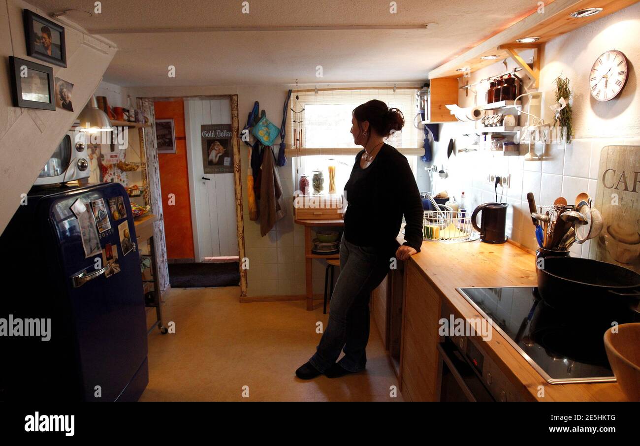Anna, a draughtswoman, poses for a photograph in her home in ...