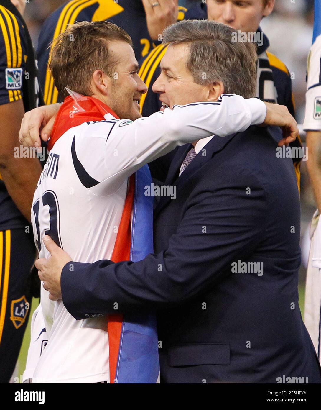 Los Angeles Galaxy's David Beckham (L) and Tim Leiweke, President and CEO of Anschutz Entertainment Group (AEG), embrace after the Galaxy defeated the Houston Dynamo to win the MLS Cup championship soccer game in Carson, California, December 1, 2012. REUTERS/Danny Moloshok (UNITED STATES - Tags: SPORT SOCCER MEDIA) Stock Photo