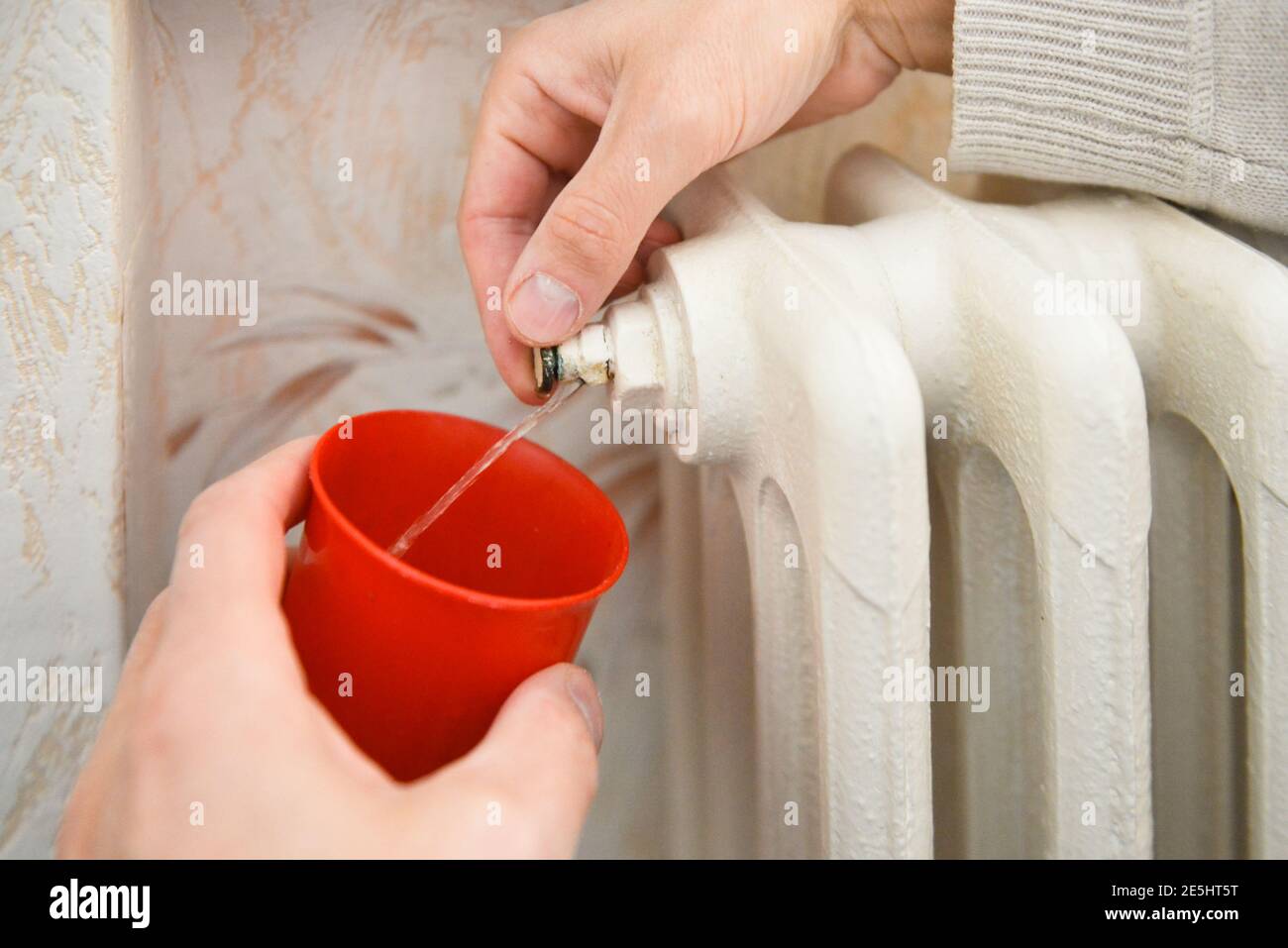 Hand draining air from a radiator Stock Photo Alamy