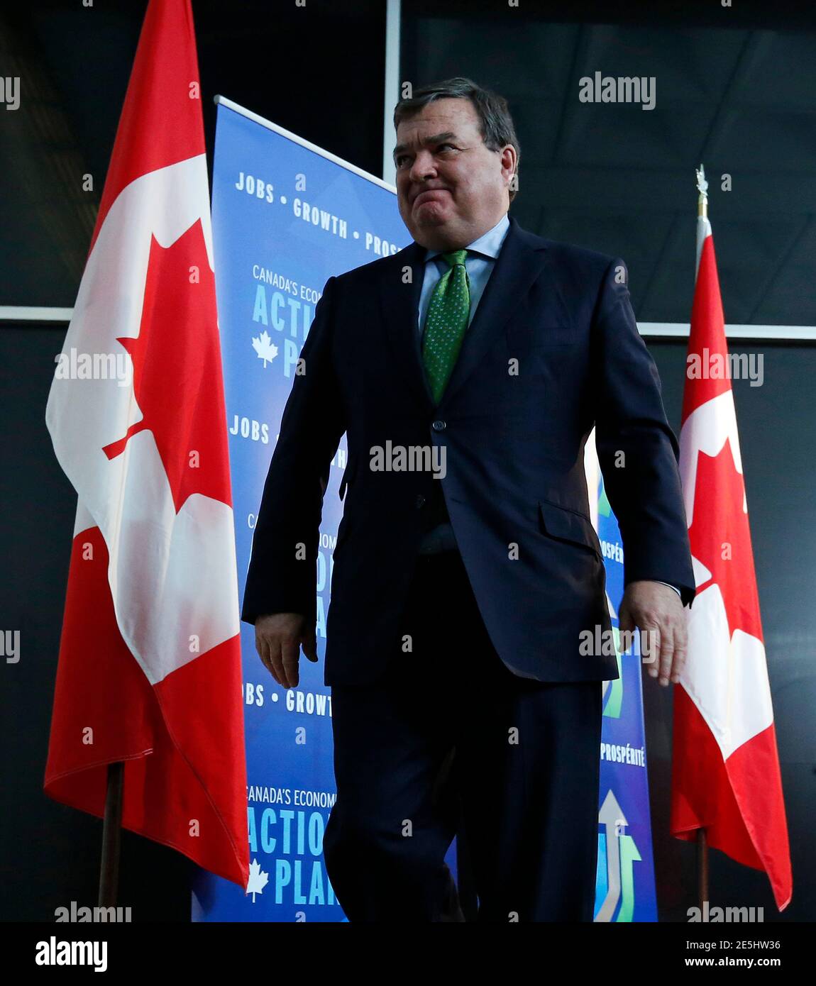 Canada's Finance Minister Jim Flaherty leaves following a news conference in Ottawa March 1, 2013. The slowing Canadian economy means the government will have lower revenues than it initially forecast as it draws up the next budget, which is due soon, Flaherty said on Friday. REUTERS/Chris Wattie (CANADA - Tags: POLITICS BUSINESS) Stock Photo
