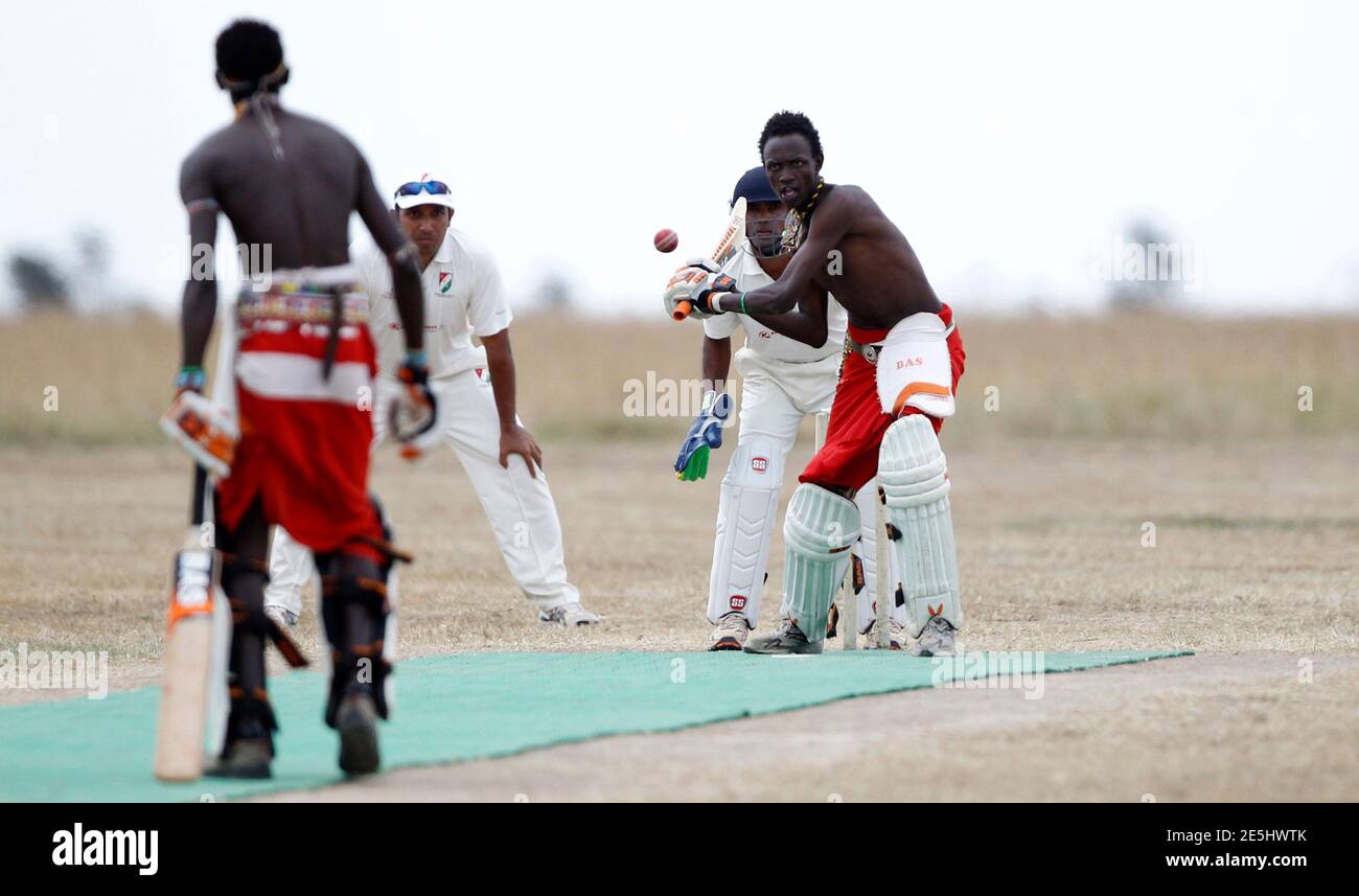 Daniel Ole Mamai of the Maasai Cricket Warriors plays a shot against the Ambassadors of Cricket from India plays in a T20 cricket match in Ol Pejeta conservency in Laikipia national park, June 6, 2013. The Maasai Cricket Warriors are role models in their communities where they actively campaign against retrogressive and harmful cultural practices, such as female genital mutilation and early childhood marriages, while fighting to eradicate discrimination against women in Maasailand. Through cricket, they hope to promote healthier lifestyles and to also spread awareness about HIV/AIDS amongst yo Stock Photo