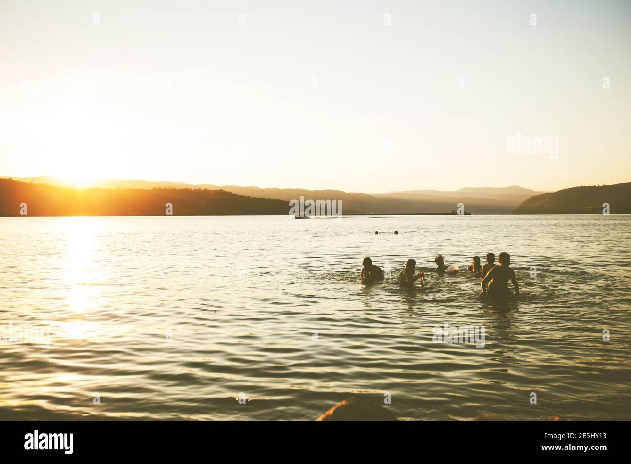 Summer Fun, Friends Enjoy Sunset On The Beach, Splashing In Water Stock Photo