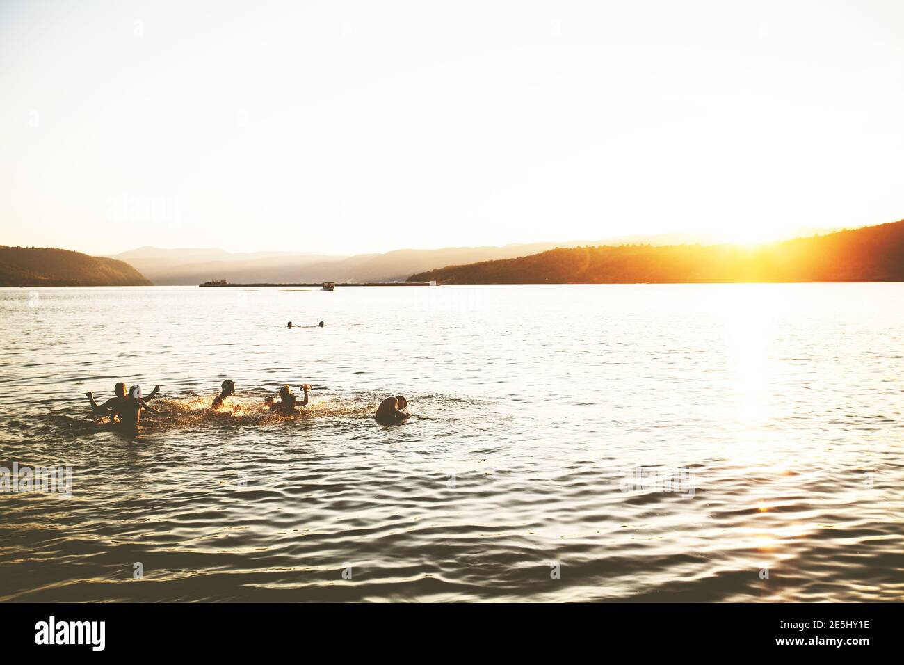 Summer Fun, Friends Enjoy Sunset On The Beach, Splashing In Water Stock Photo