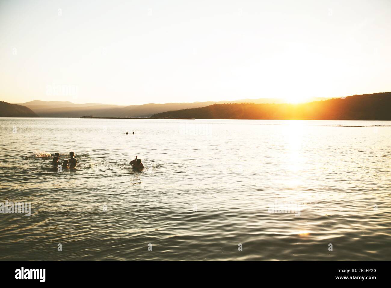 Summer Fun, Friends Enjoy Sunset On The Beach, Splashing In Water Stock Photo