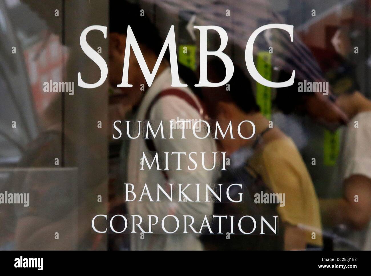 https www alamy com people using atms are seen through a sign on a glass door at a branch of sumitomo mitsui banking corporation in tokyo july 30 2014 sumitomo mitsui financial group inc smfg on wednesday said first quarter profit fell 20 percent as gains in the value of stock holdings paled in comparison with the year prior when prices rose after government promises of economic growth reutersyuya shino japan tags business logo image399308064 html
