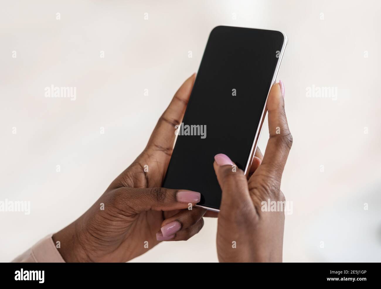 Modern Smartphone With Black Blank Screen In Hands Of Unrecognizable Black Lady, Mockup Image Stock Photo