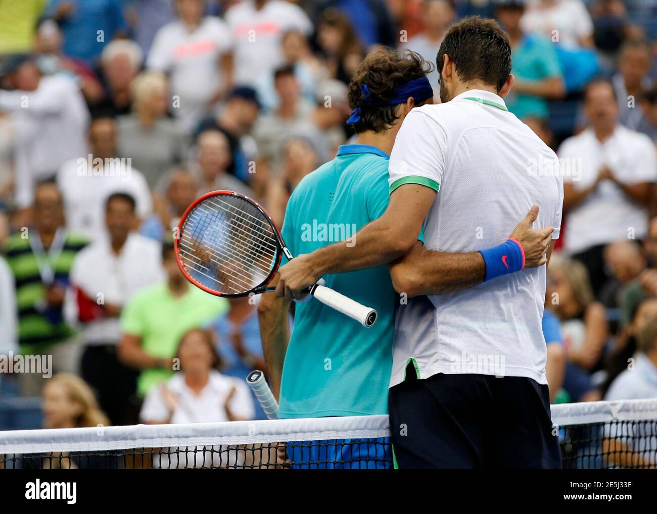 Marin Cilic of Croatia (R) and Roger Federer of Switzerland embrace after Cilic their semi-final match at the 2014 U.S. Open tennis tournament in New York, September 6, 2014. REUTERS/Mike Segar (