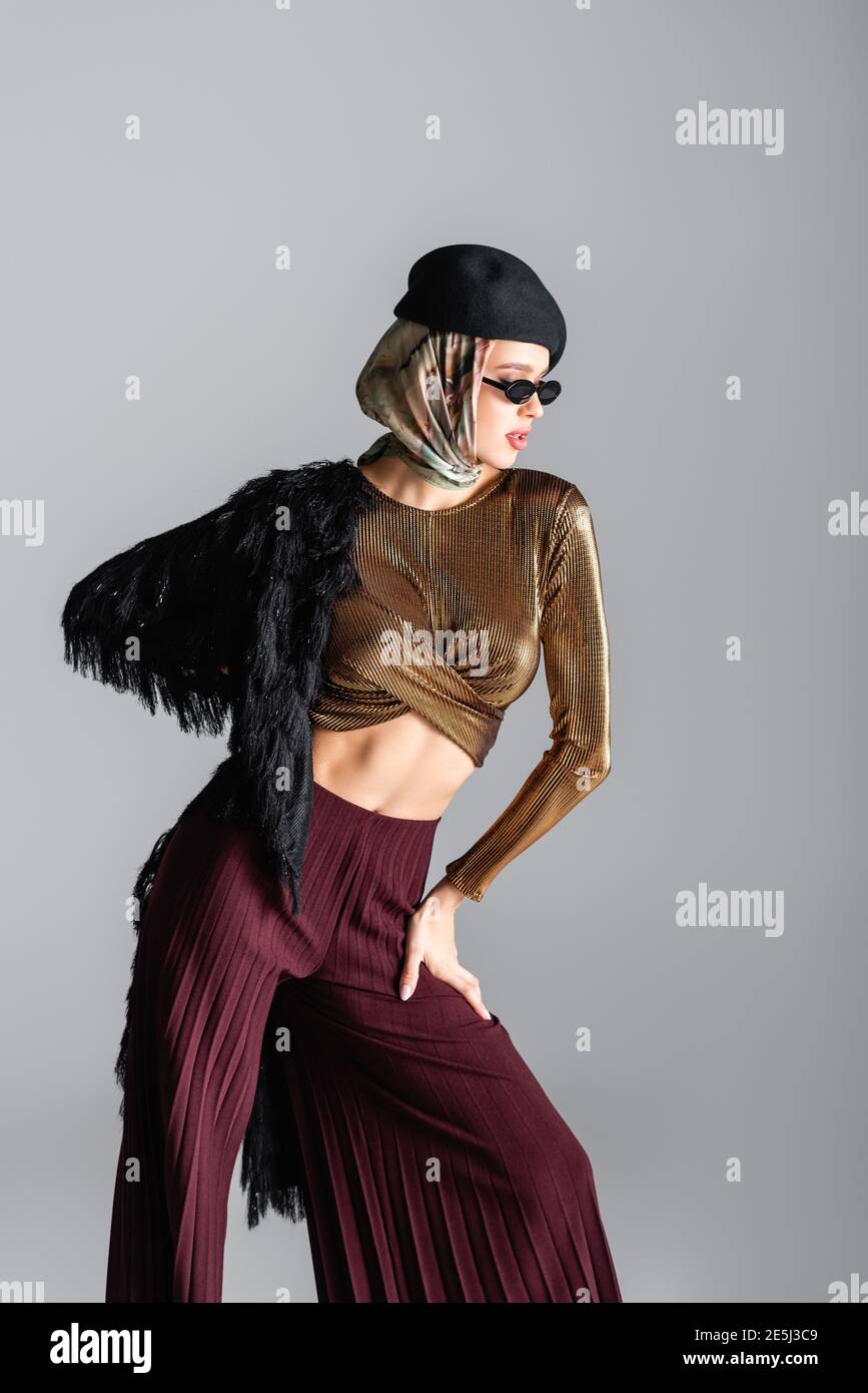 stylish woman in sunglasses and beret posing on grey Stock Photo - Alamy