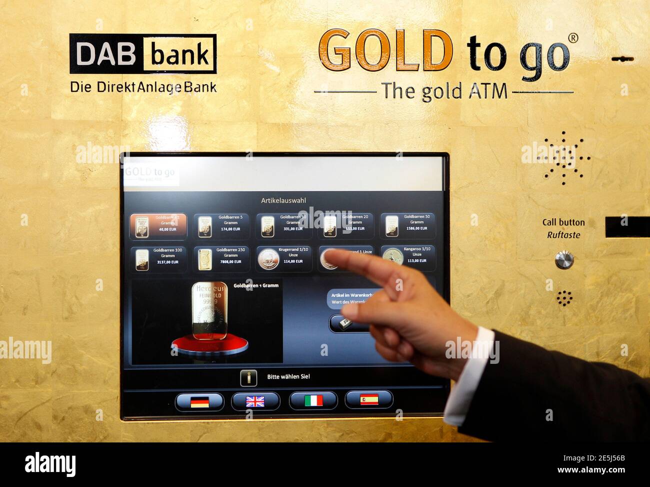 Gold-to-go founder Thomas Geissler demonstrates using one of Germany's  first gold-plated ATM (automated teller machine) in a bank in Munich  September 30, 2010. The machine, which features cutting-edge technology,  dispenses 1g, 5g,