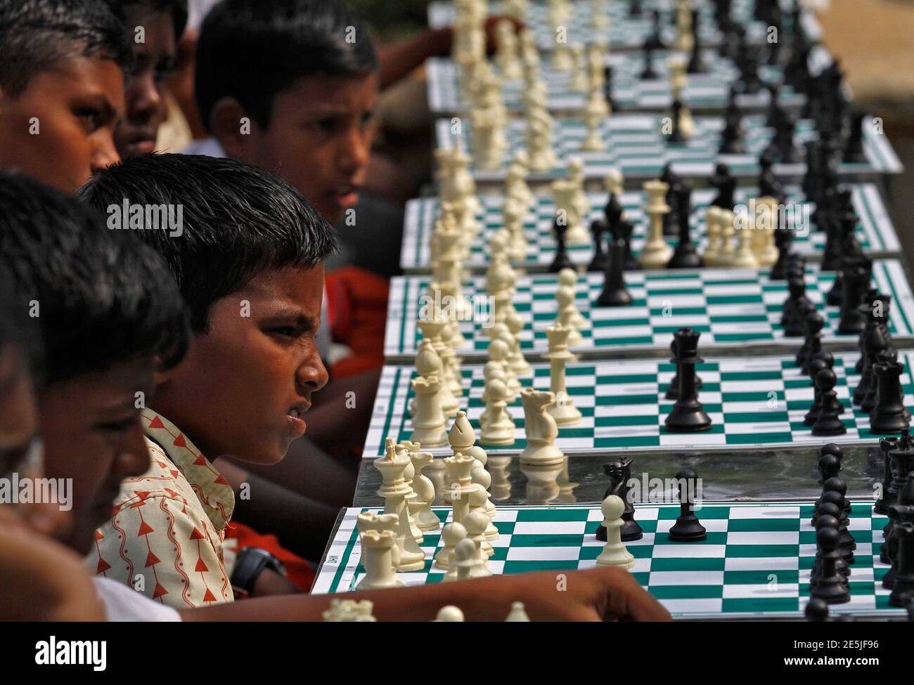 School children play chess in a public park as part of a chess promotional  campaign near to the venue where Norway's Magnus Carlsen and India's  Vishwanathan Anand are playing in the FIDE