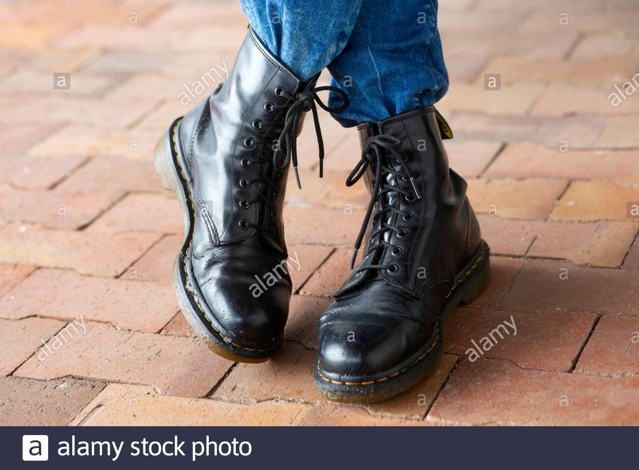 Black strong Dr Marten boots in snow on a winter's day. Stock Photo