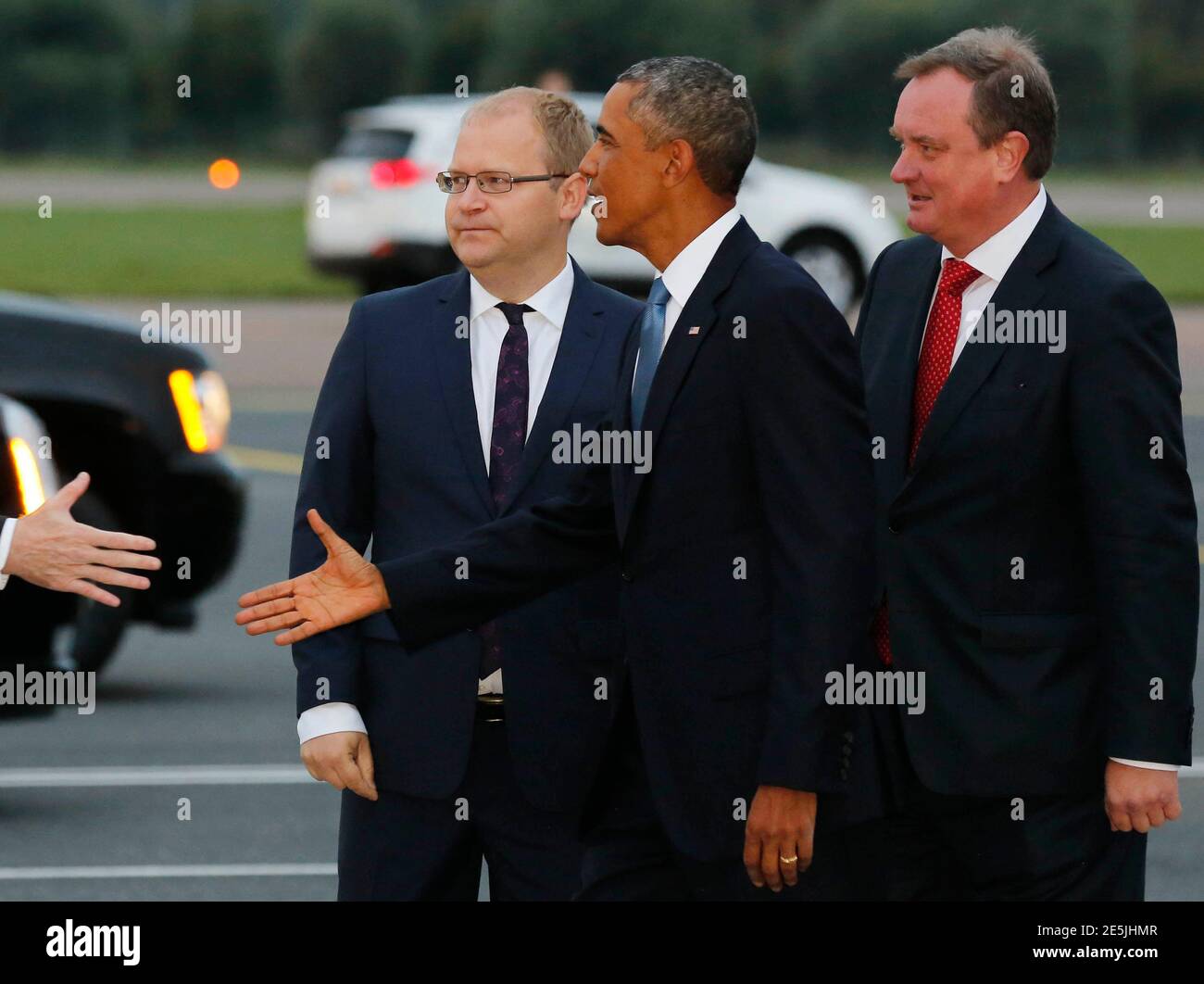 U.S. President Barack Obama is greeted by Estonia Foreign Minister Urmas  Paet (L) and Chief of Protocol Toomas Kahur (R) after arriving at Tallinn  Airport in Tallinn, Estonia, September 3, 2014. REUTERS/Larry