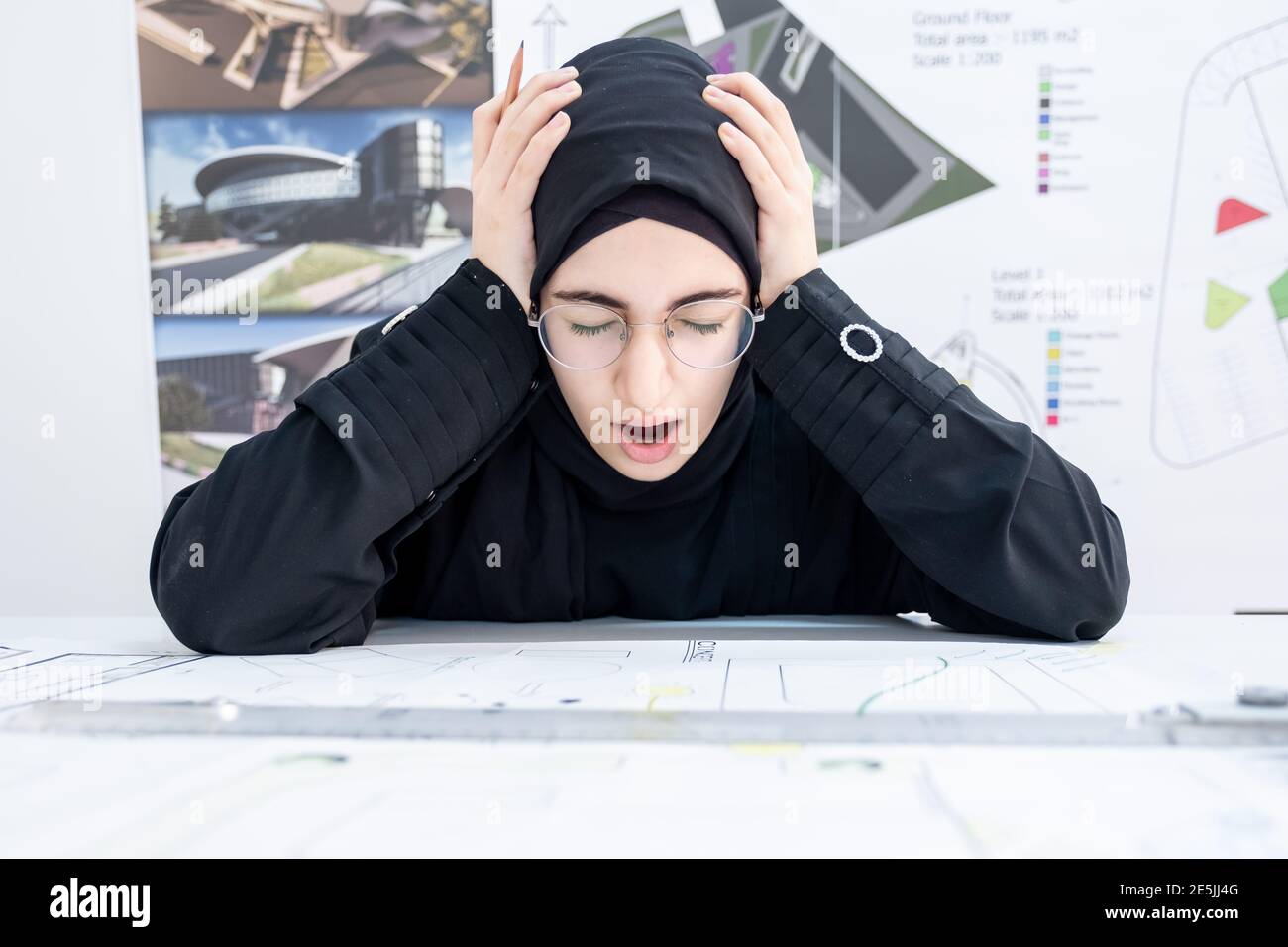 Arab female architect feeling tired Stock Photo
