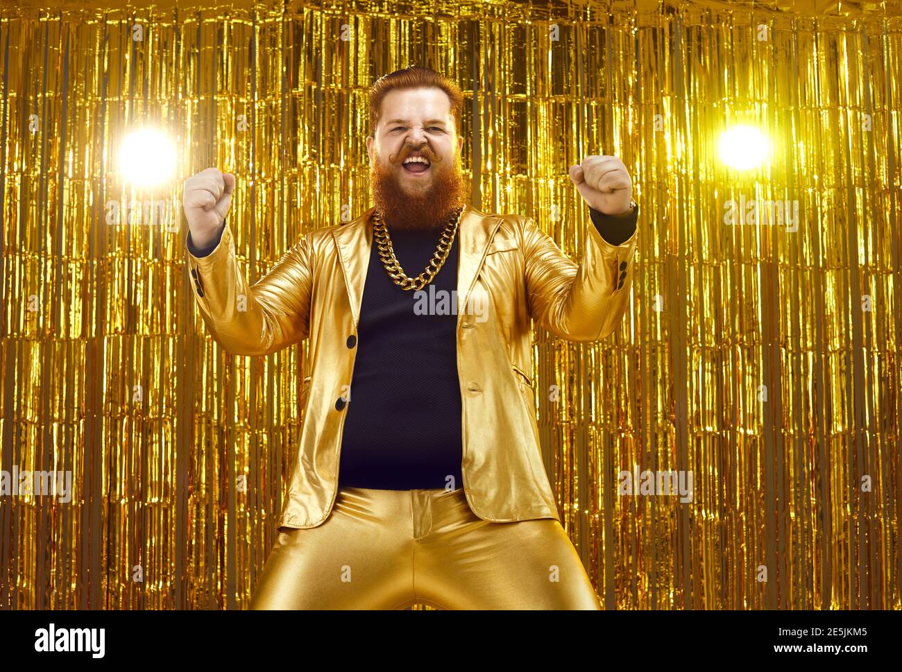 Funny chubby man in funky suit and gold chain dancing and celebrating his success Stock Photo