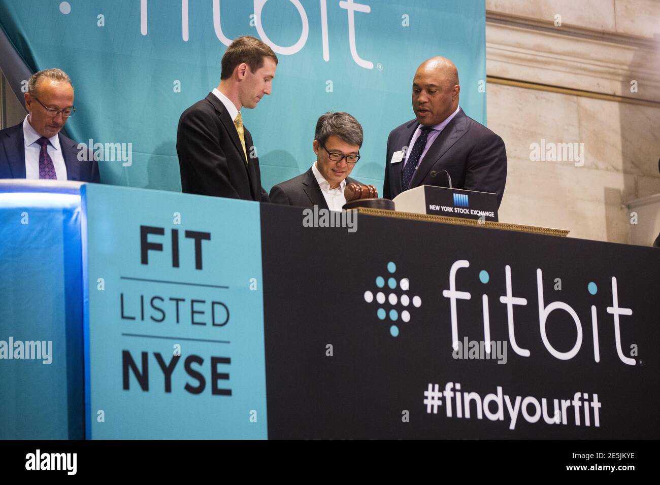 James Park (2nd R), Fitbit CEO, stands with co-founder and CTO Erid  Friedman (2nd L) before ringing the opening bell on the day of the  company's IPO above the floor of the