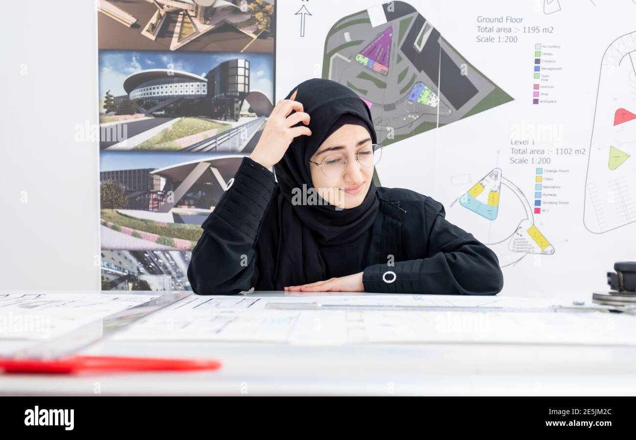 Arab female architect feeling tired and thinking Stock Photo