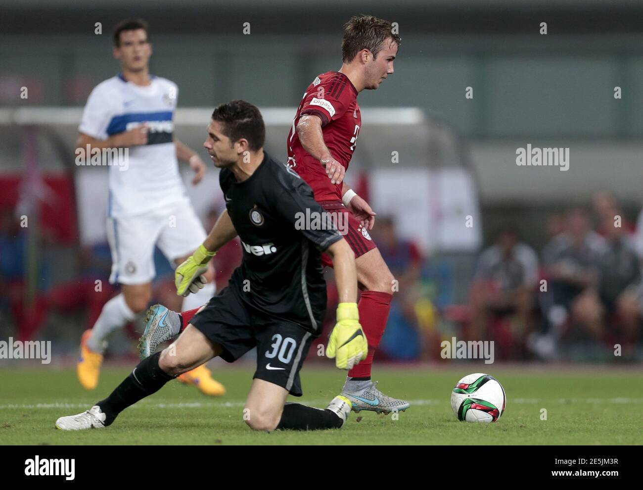 Mario Gotze (R) of FC Bayern Munich fights for the ball with Juan Pablo Garrizo of FC Internazionale during their team's friendly match in Shanghai, July 21, 2015. REUTERS/Aly Song Stock Photo