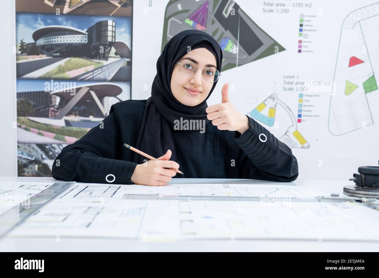 Female architect working and showing thump up Stock Photo